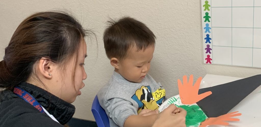 Child and adult doing a craft project.