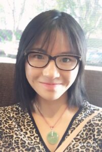 Person smiling wearing glasses and leopard print.